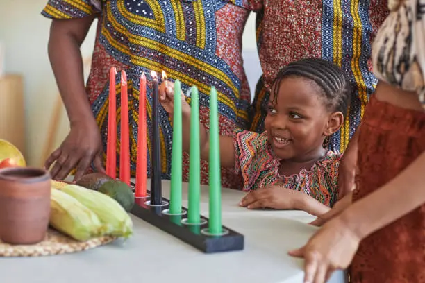 Photo of Little child burning candles for holiday