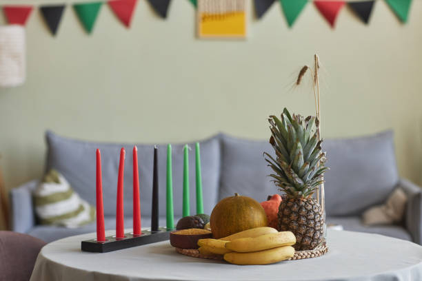 Candles and exotic fruits for Kwanzaa holiday Horizontal image of candles and exotic fruits for Kwanzaa holiday on table in living room angolan kwanza photos stock pictures, royalty-free photos & images