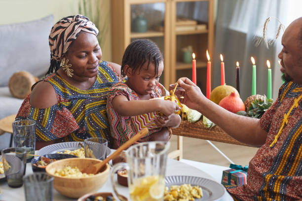 istock Little girl opening present with her parents 1425283951