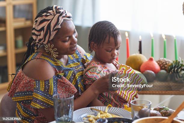 Mom Opening Gift With Her Child Stock Photo - Download Image Now - Kwanzaa, Angolan Kwanza, Family