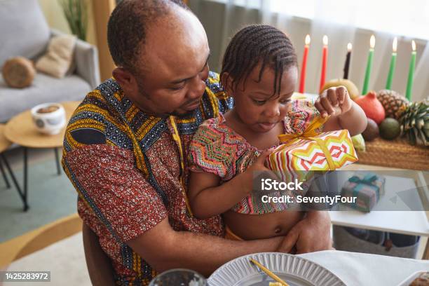 Little Girl Opening Gift Box Stock Photo - Download Image Now - Kwanzaa, Angolan Kwanza, Child