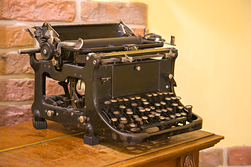 Vintage typewriter on wooden surface.