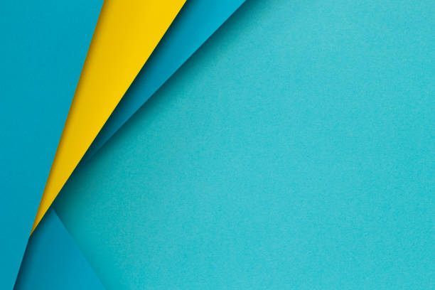 Abstract color papers geometry flat lay composition background with light blue and yellow tones. Top view