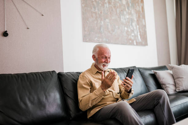 istock Senior man having video call at home 1425284897