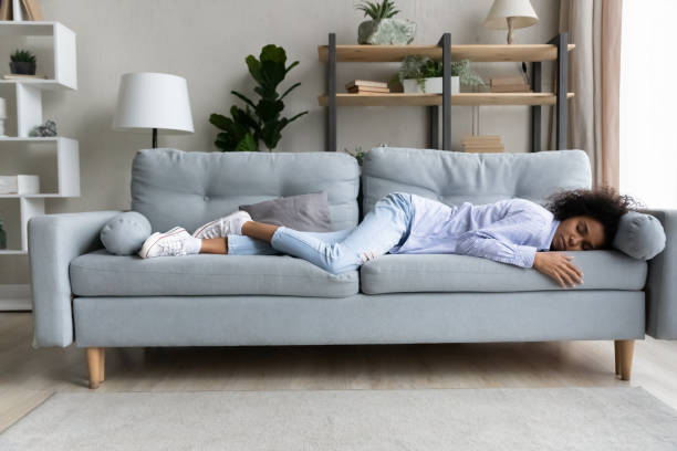 istock Full length relaxed African American woman sleeping on comfortable couch 1425285773