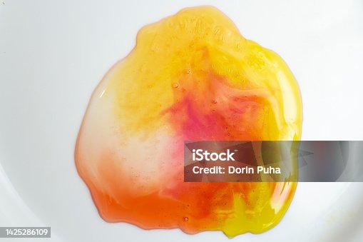 istock Melted multicolored jelly bears, in white background. 1425286109
