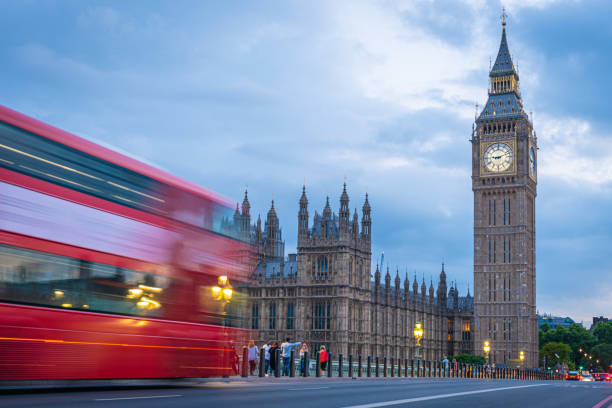 istock Big Ben with blurred double decker bus at blue hour 1425288484