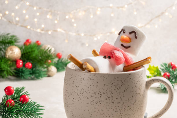 istock Mug with hot chocolate with melted marshmallow snowman 1425289314