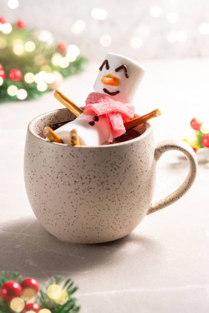istock Mug with hot chocolate with melted marshmallow snowman 1425289381