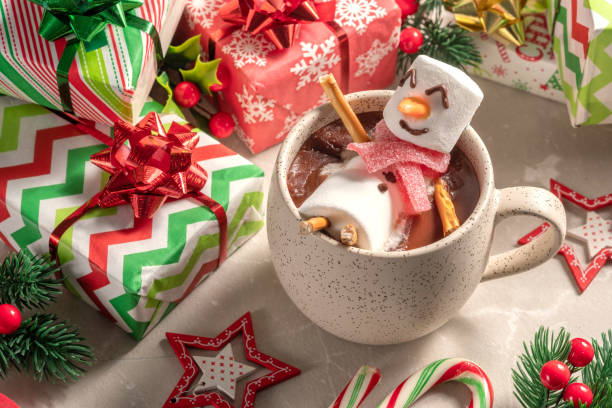 istock Mug with hot chocolate with melted marshmallow snowman 1425289402