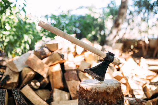 An axe stuck in a piece of wood