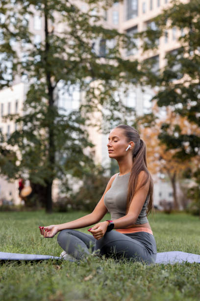 istock Woman clearing her mind and meditating in park 1425292646
