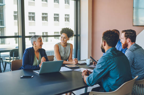istock Diversity, leadership and coaching a team at a startup in a meeting. Strategy, planning and management, men and women in an office with woman coach or mentor. Teamwork, learning and working together. 1425293662