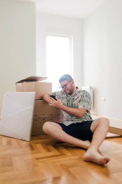 istock Young man using his phone to shop online at home 1425295113