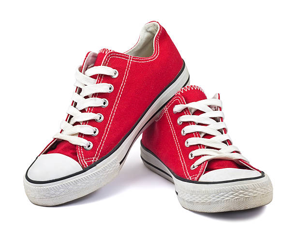 Red converse sneakers on white background stock photo