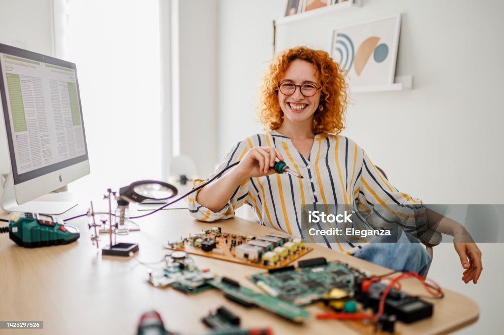 Computer repair service. Hardware support. Electronic technology. Shot of technician fixing laptop cooler Adult Stock Photo