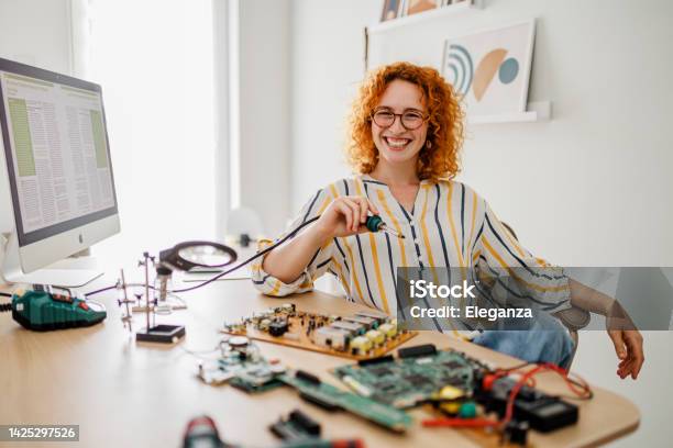 Computer Repair Service Hardware Support Electronic Technology Shot Of Technician Fixing Laptop Cooler Stock Photo - Download Image Now