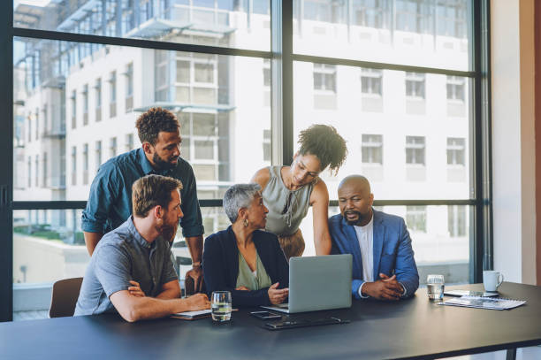 istock Collaboration, training and teamwork with a female leader, manager or CEO meeting with her team and discussing the company mission and vision. Growth, development and coaching with a boss and staff 1425300624