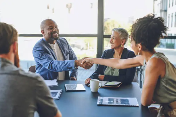 Shaking hands, b2b and a thank you handshake in business meeting collaboration after a partnership deal agreement. Contract, diversity and management welcome a new team member on a global project
