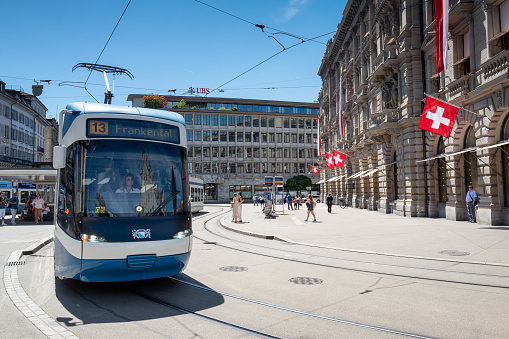 Zurich, Switzerland - July 11, 2022: modern Streetcar Leaving the Paradeplatz rail station travelling on Bahnhofstrasse in Zurich.. Historic center of banking operations