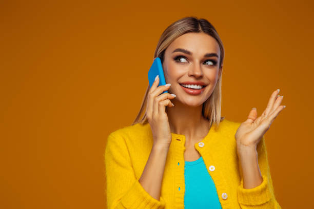 istock Beautiful emotional woman using smart phone 1425302176