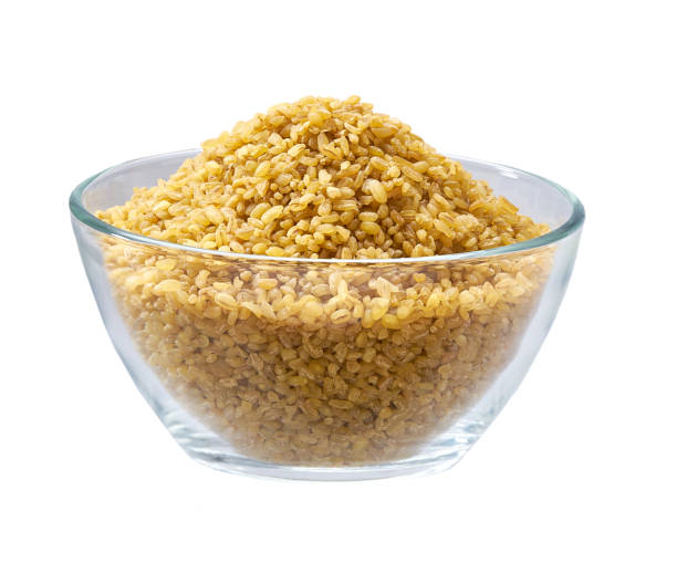 istock bulgur in a clear glass bowl isolated on white background. 1425302325
