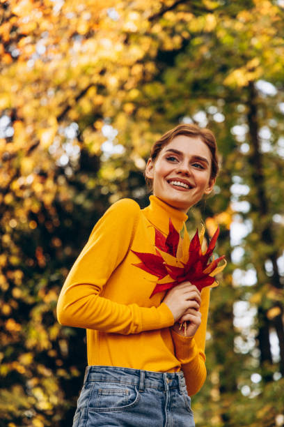 istock Beautiful woman enjoying autumn 1425302839