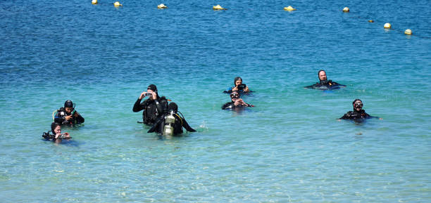 Playa Blanca, Lanzarote, Spain - March 21, 2022: Group of people having a scuba diving lesson.