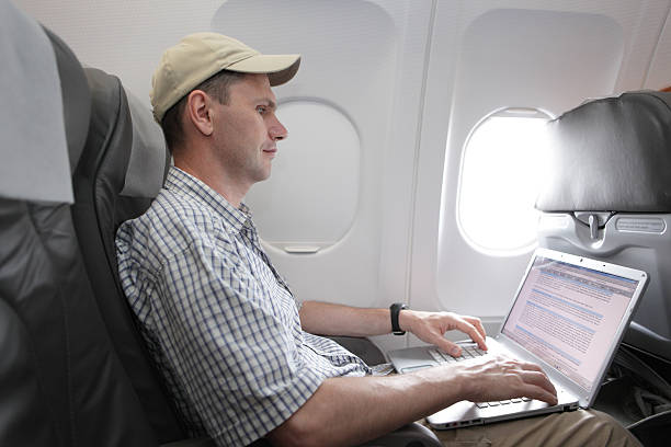 istock Passenger with laptop in airplane 142530471