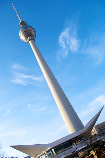 The famous Berlin TV tower near Alexanderplatz in a summer day. Cloudly sky in the background.