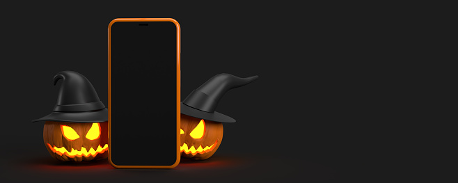 Halloween 3D Concept: Two spooky smiling orange pumpkins with witch hats sitting on black background behind an empty mobile phone device screen, copy space. Your message here seasonal illustration template with clipping path.