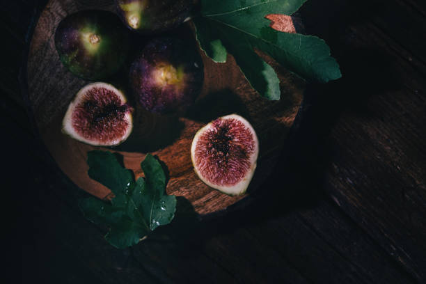 istock top down view on figs on a cutting board,   dark photography. 1425306919