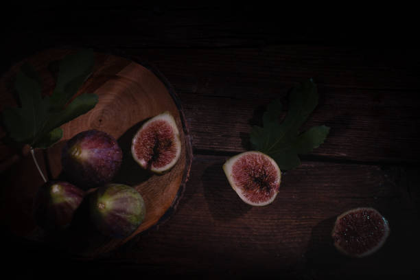istock top down view on figs on a cutting board,   dark photography. 1425306936