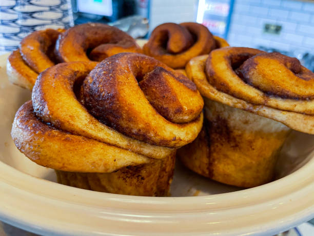 istock Close-up image of cafe bakery display, batch of cinnamon swirl buns on plate, focus on foreground 1425308476