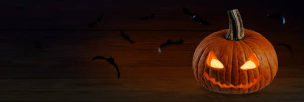 istock Smiling scary Halloween pumpkins on a dark background 1425311165