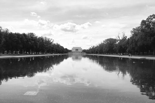 Landscape image in black & white of the Lincoln Memorial reflecting into the Reflecting Pool on an overcast summer afternoon in Washington, D.C.