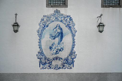Virgin Mary in blue and white portuguese azulejo tiles on the wall of the former Church and Monastery of Carmo - Guimaraes, Portugal
