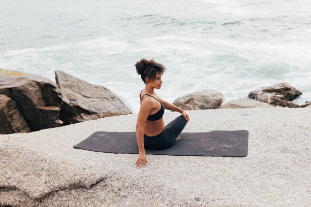 istock Woman doing side turn on mat warming up her body before yoga training 1425318752