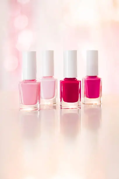 Shades of pink and red nail polish set on glamour background, nailpolish bottles for manicure and pedicure, luxury beauty cosmetics and make-up brand ad