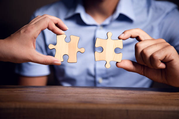 istock A man and a woman are holding a puzzle 1425319275