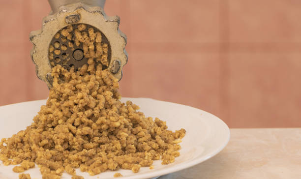 istock Chopped walnut kernels through a mincer close up - Recipe concept 1425320945