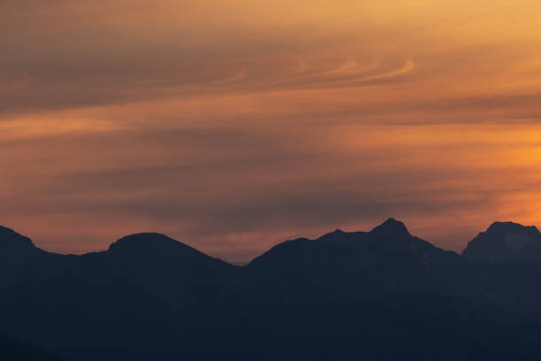 istock Silhouetted Western Ridge With Wispy Clouds Over Glacier 1425321222