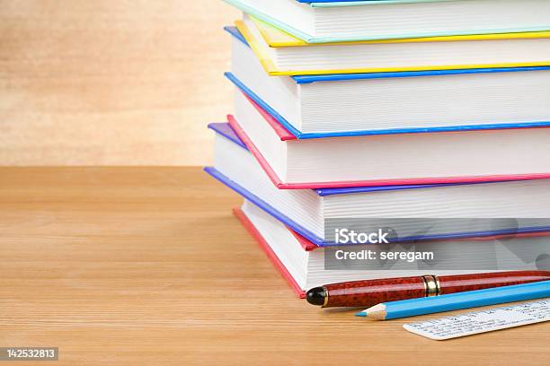 Pile Of Books On Wood Stock Photo - Download Image Now - Black Color, Blue, Brown