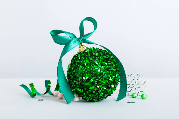 istock Christmas ball on colored background. decoration bauble with ribbon bow with copy space 1425328657