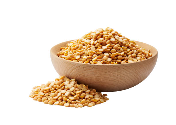 istock dried peas in a wooden bowl isolated on white background. 1425329440