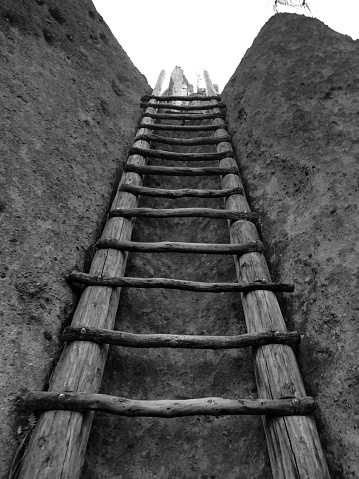 A wooden ladder leads to a cavate on the Pueblo Loop Trail in Bandelier National Monument in New Mexico