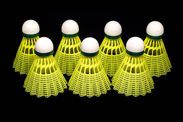 istock Seven yellow badminton shuttlecocks isolated on black 142533259