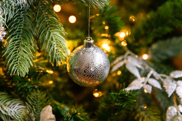 istock Classic Christmas decorated New year tree. Christmas tree with wite and silver decorations, ornaments toy and ball. Modern classical style interior design apartment. Christmas eve at home. 1425333056