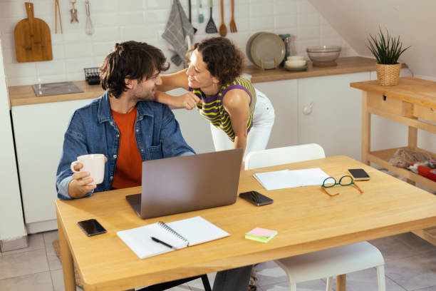 istock Happy couple doing business together 1425338797