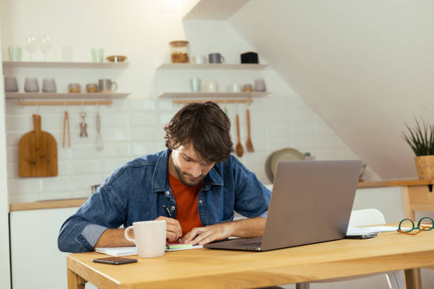 istock Young man starting his working day at home office 1425338855